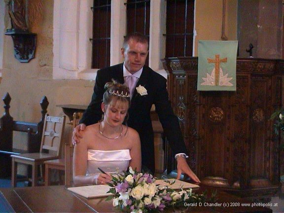 Cris and Sam signing wedding papers