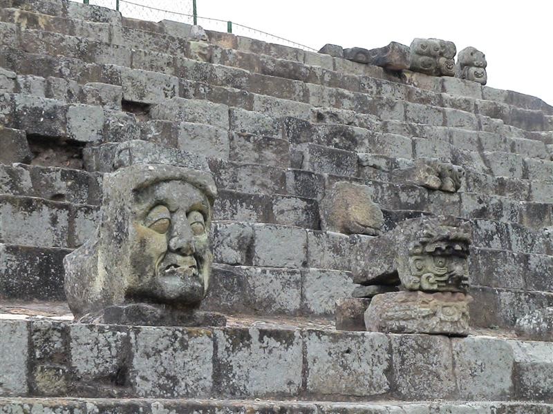 Carved heads along a wall