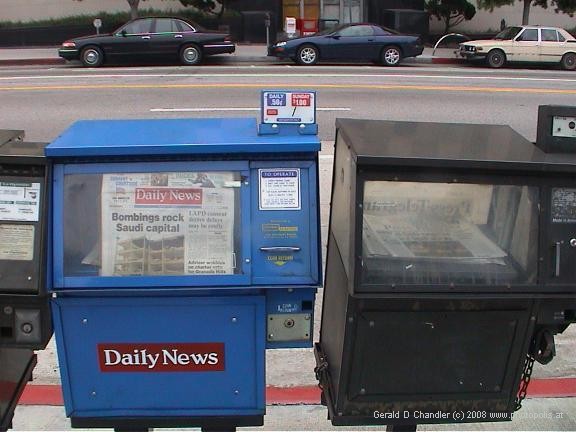 Headlines of day on newspapers in street vending box