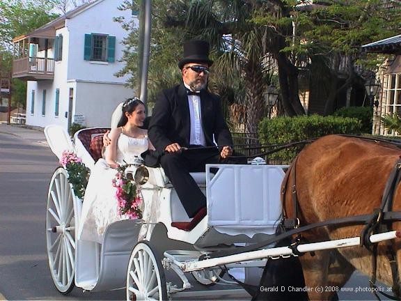 Wedding Couple in open horse drawn carriage